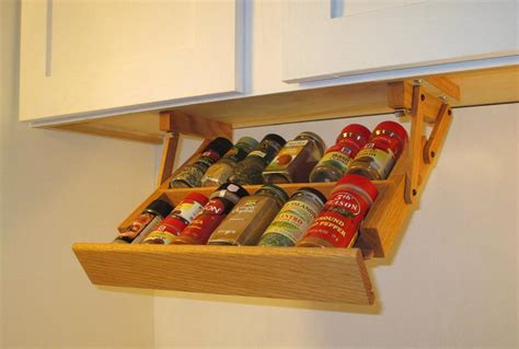 All you have to do is cut a cork board to fit the interior of one of the cabinet doors and to glue it in place. Ultimate Kitchen Storage Under Cabinet Mini Spice Rack ...