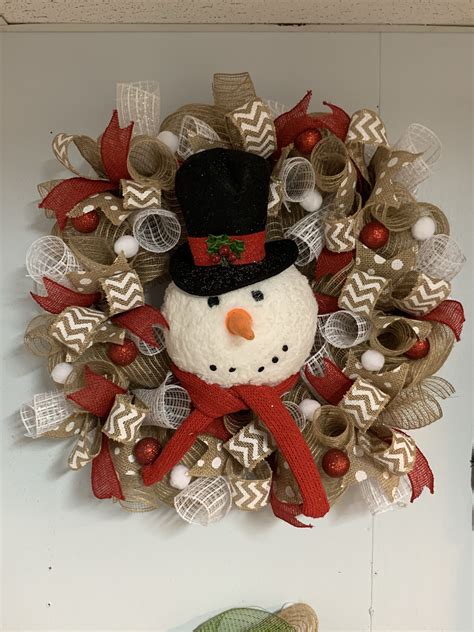 A Christmas Wreath With A Snowman On It