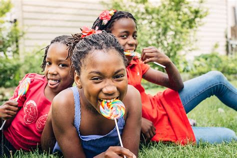 three black girls with lollipops laughing by stocksy contributor gabi bucataru stocksy