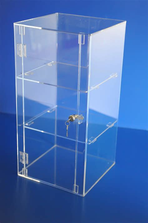 A Clear Plastic Box With Keys In It On A Blue Surface Showing The Inside