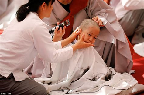 Young Monks Sob As They Have Their Heads Shaved During Buddhist