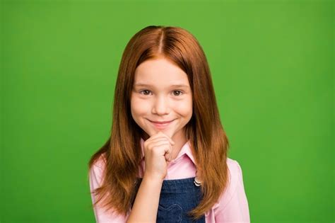 Premium Photo Little Redhead Girl Posing Against The Green Wall