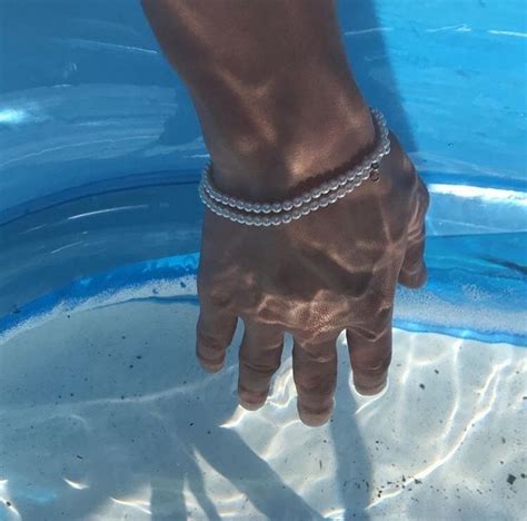 A Person S Hand In The Water Wearing A Bracelet