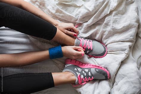 Woman Tying Laces On Running Sneakers By Lumina Stocksy United