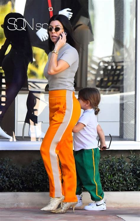 kardashian style kourtney kardashian sensual dress orange pants lauren london shirt tucked
