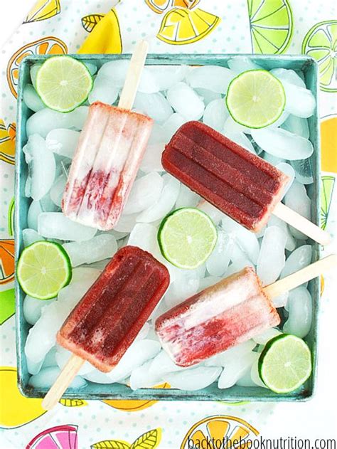 Three Popsicles With Limes And Ice On A Tray