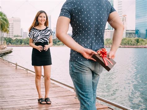 Man Surprises His Girlfriend By Giving Out A Gift Stock Photo Ad