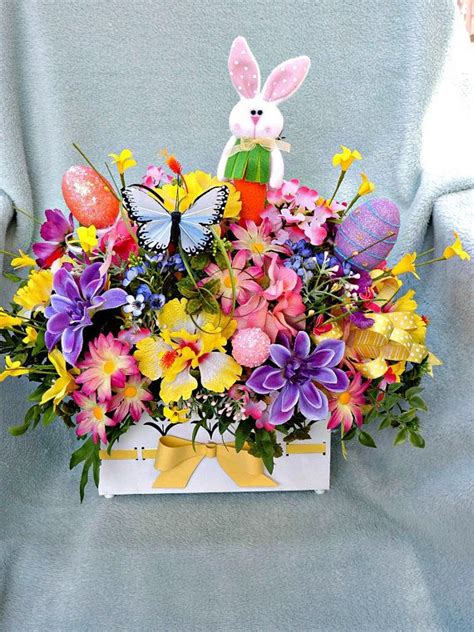 A Basket Filled With Lots Of Colorful Flowers And An Easter Bunny