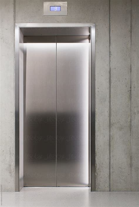 closed lift or elevator doors del colaborador de stocksy amir kaljikovic stocksy