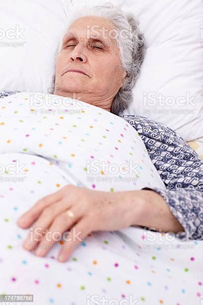 An Elderly Person Sleeping In Bed Stock Photo Download Image Now 60