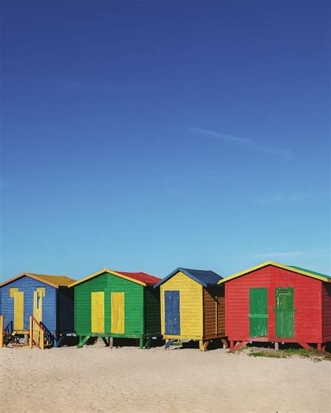 Colorful Beach Huts Under Blue Sky · Free Stock Photo