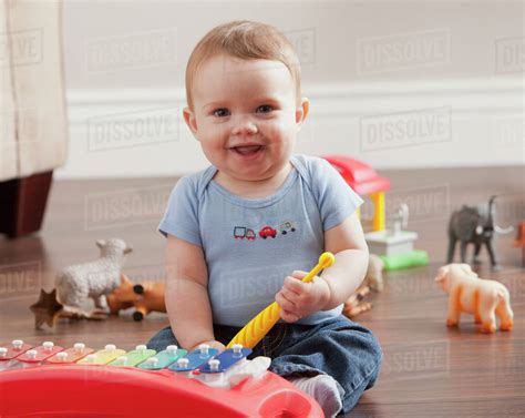 Caucasian Baby Boy Playing With Xylophone Stock Photo Dissolve