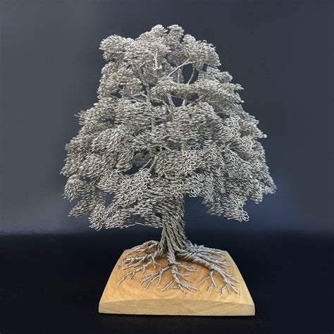 This is a marvelous piece of jewelry with. Artist Turns Single Strands Of Wire Into Elaborate Tree ...