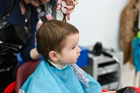 Premium Photo Child At The Hairdresser Close Up The First Haircut Of