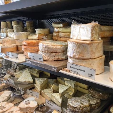 Cheeses And Other Food Items On Display In A Store