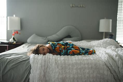 Child Sleeping On Large Bed By Stocksy Contributor Courtney Rust