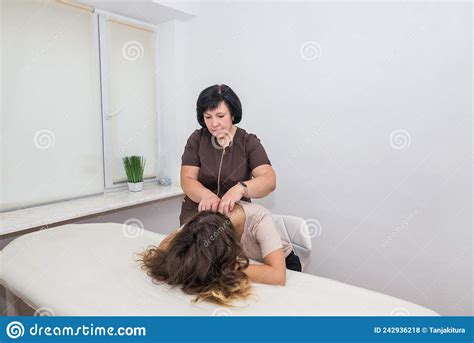 Manual Massage A Female Therapist Massages The Patient`s Shoulders And