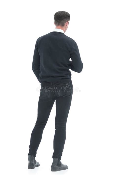Rear View Young Man Standing In Front Of A White Screen Stock Photo