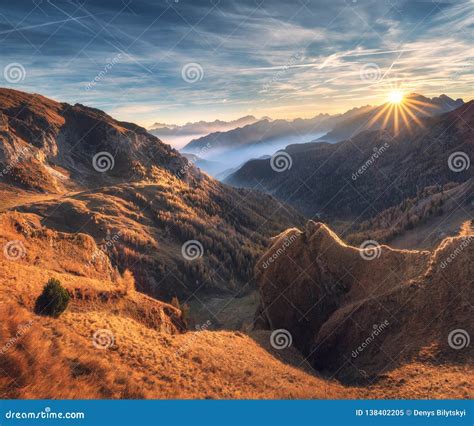 Mountains In Fog At Beautiful Sunset In Autumn Dolomites Italy Stock