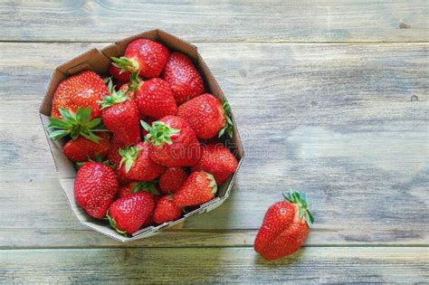 Strawberries From Market Fresh Ripe Fruit In Cardboard Box On Rustic