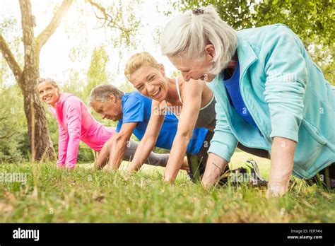 Group Of Adults Exercising Doing Push Ups Outdoors Stock Photo Alamy