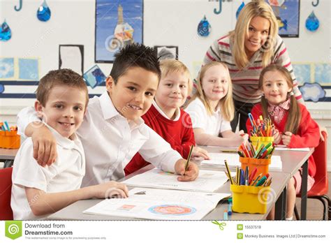 Primary Schoolchildren And Teacher Working Stock Photo Image Of Group