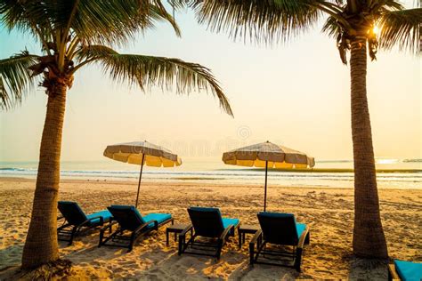 Umbrella Chair Beach With Palm Tree And Sea Beach At Sunrise Times