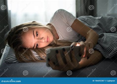 Pretty Young Woman Using Her Smart Phone In Bed Stock Image Image Of Home House 186692387