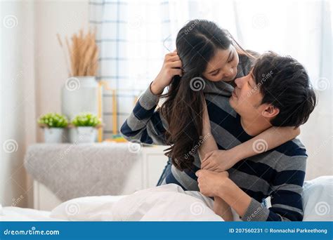Wonderful Young Asian Couple On Bed In Bedroom Hug And Enjoy Life