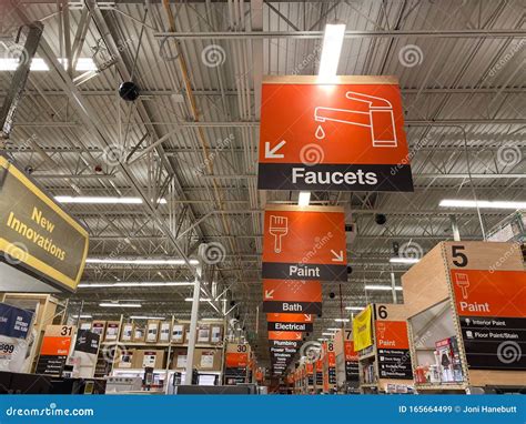 The Signs Hanging From The Ceiling At Lowes Home Improvement Store That