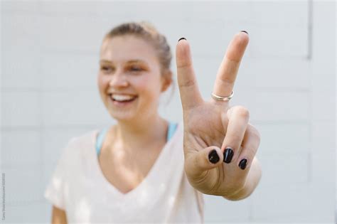 Young Woman Showing The Peace Sign By Stocksy Contributor Carey Shaw