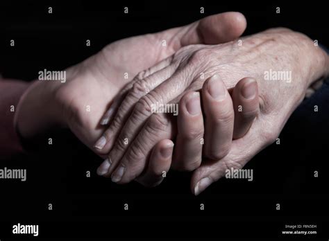 Young Woman Holding Older Womans Hand Stock Photo Alamy