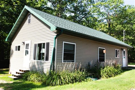 The cabins have bed frames and mattresses. Cabin with Fire Pit near Apostle Islands in Wisconsin