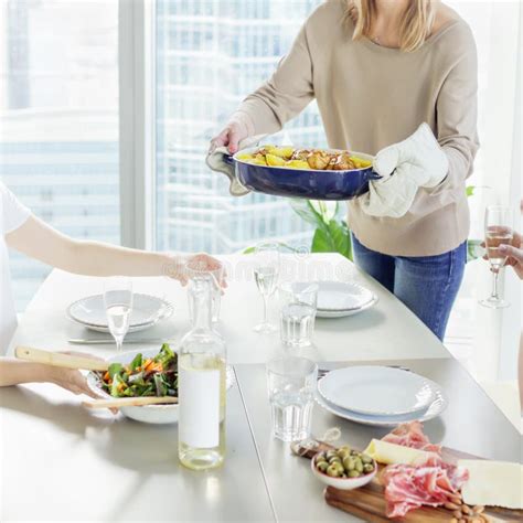 Close Up Of Woman Bringing Dish To The Table Stock Photo Image Of