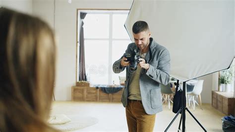 Professional Photographer Taking Photos Of Model On Digital Camera