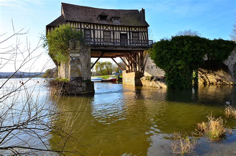 Old House Built On A Ruined Medieval Bridge In Normandy France