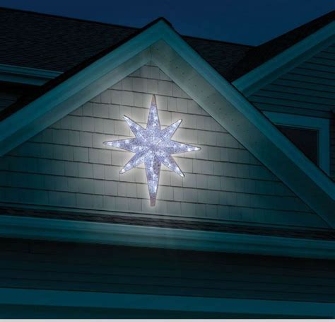 A Lighted Star On The Side Of A House