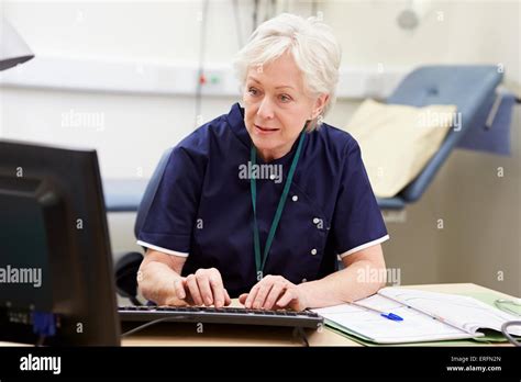 Female Nurse Working At Desk In Office Stock Photo Alamy
