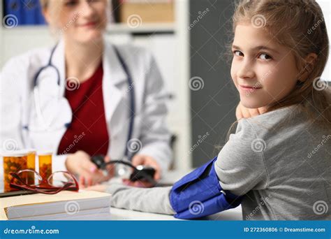 Doctor Measures Blood Pressure Of Little Girl Child Stock Photo Image