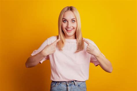 Crazy Blonde Woman Showing Tongue Keeping Palms On Face Wearing Black