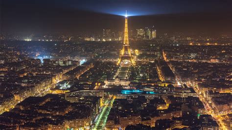 Eiffel Tower With Yellow Lights And Blue Light On Top And