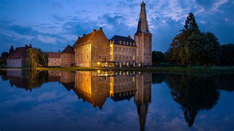 Castle With Reflection On Calm Body Of Water In Germany During