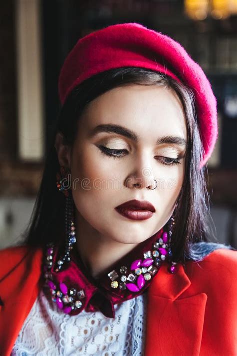 Beautiful Brunette Model With Blue Eyes In A Red Beret Is Looking
