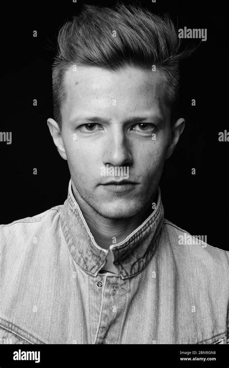 Punk Rocker Man Against Black Background In Black And White Stock Photo