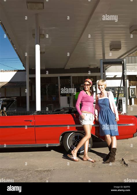 Two Women At A Gas Station Stock Photo Alamy