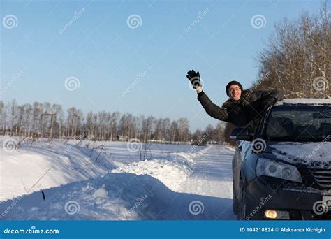 Man Looks Out The Car Window At The Snow Covered Road Stock Photo