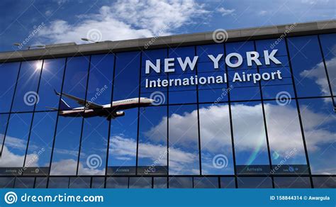 Airplane Landing At New York Jfk Kennedy Mirrored In Terminal