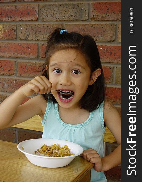 Young Asian Girl Eating Breakfast Cereal Free Stock Images And Photos