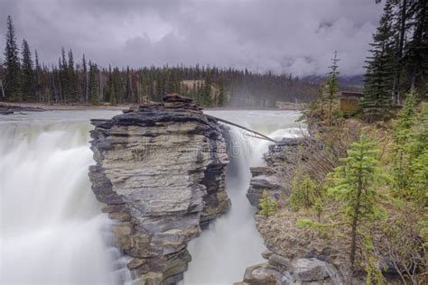 Athabasca Falls In The Rocky Mountains Of Canada Between The Cliffs