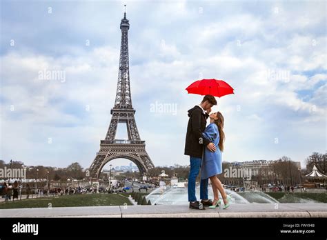 Beautiful Couple With Umbrella Near Eiffel Tower Honeymoon In Paris
